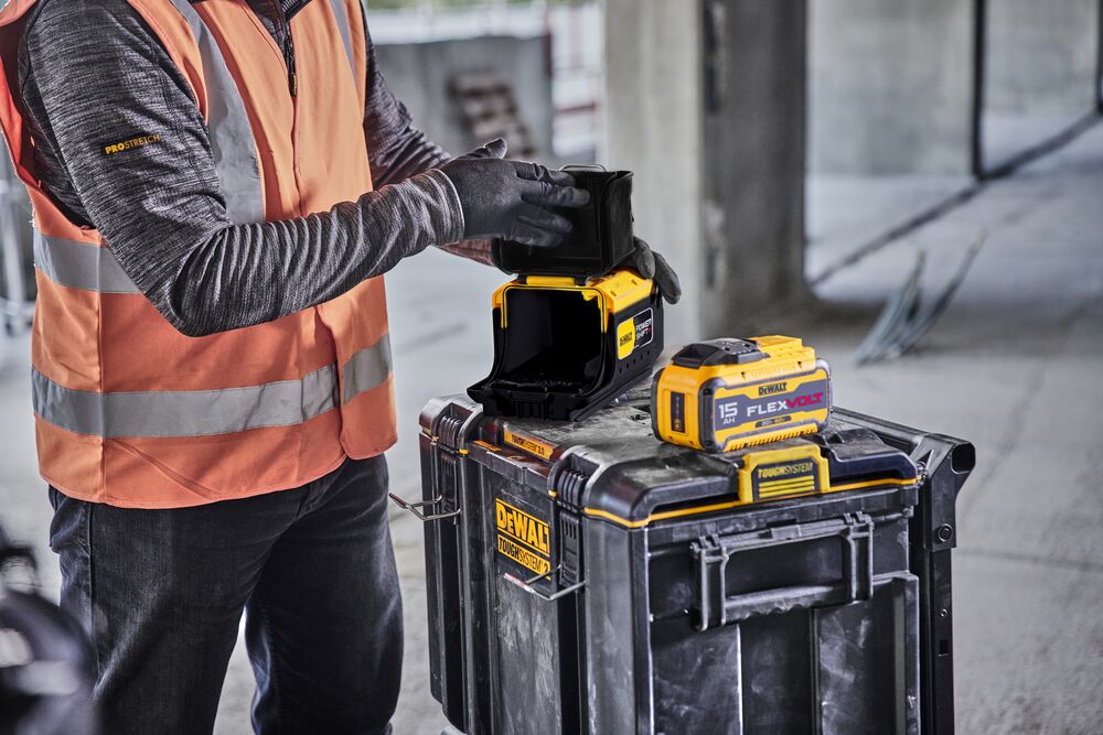 Man inserting battery into adapter