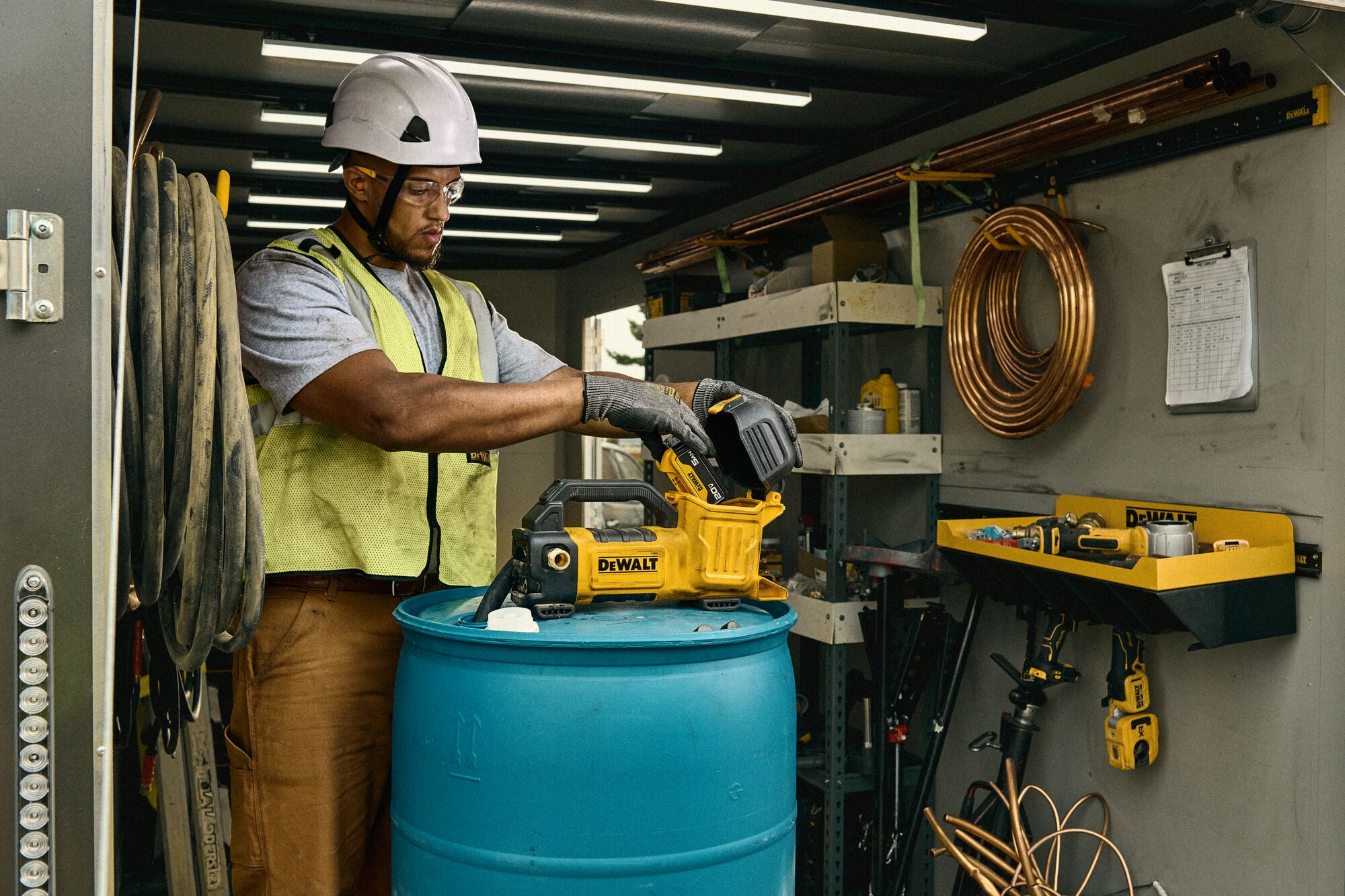 DEWALT Transfer Pump in the back of a truck connected to a drum. 